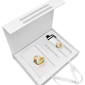Open white magnetic gift box set with a notebook, pen and white bottle, printed for UAE National Day